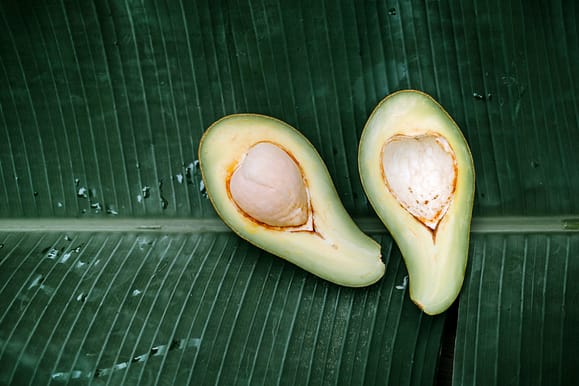 sliced avocado fruit on a banana leaf